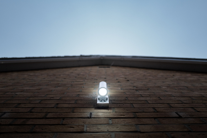 Vertical focus of a PIR LED security light seen lit on the outside of a new home.